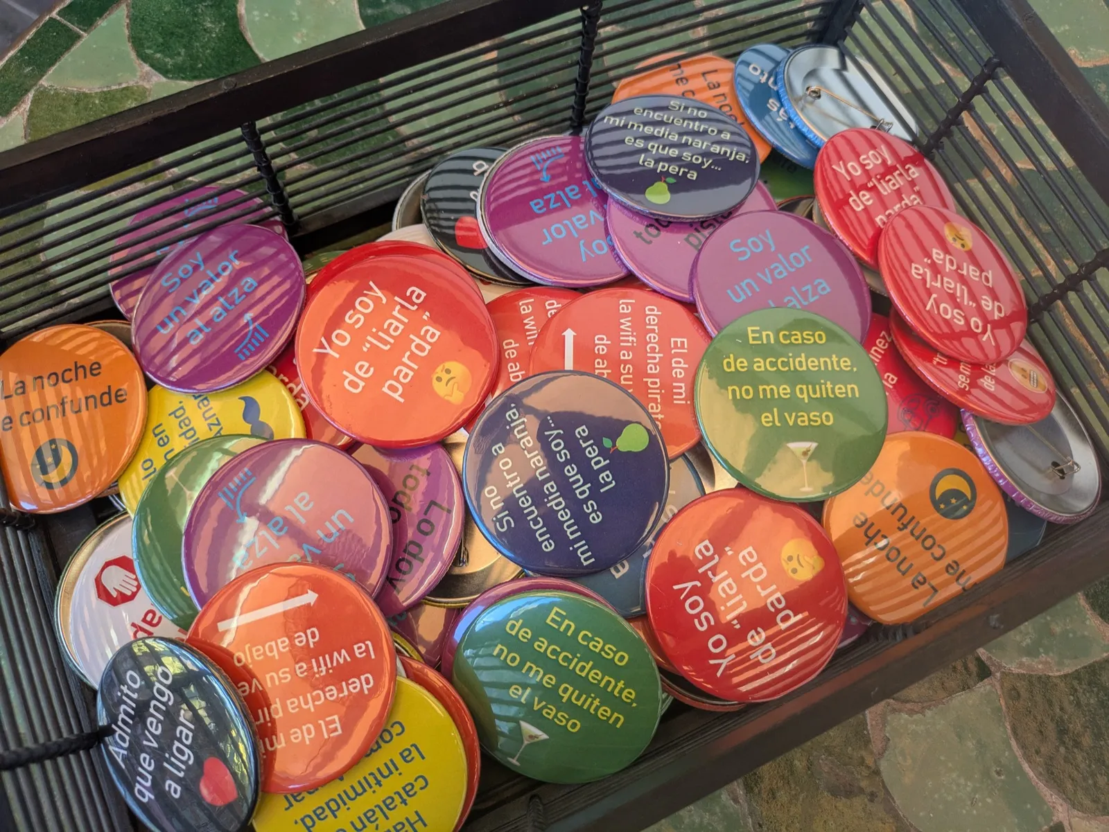 Caja de chapas de colores con frases del evento como detalle de la jornada